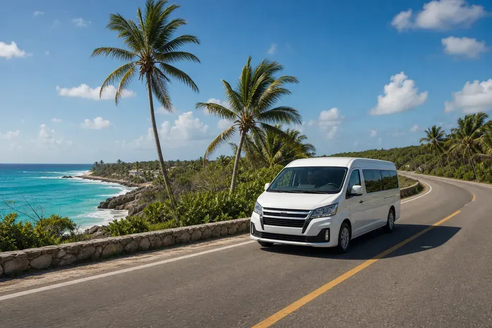 White private transfer van on coastal highway from Cancun Airport to Tulum beach hotels