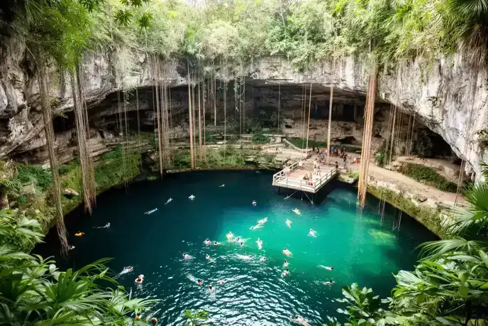 Cenote Ik Kil swimming platform with turquoise water and hanging vines near Chichen Itza