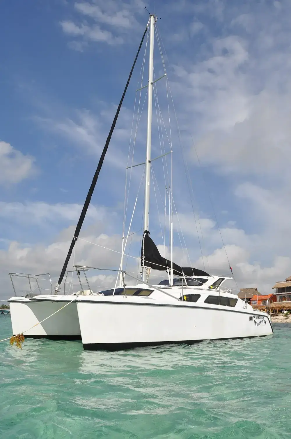 Private sailing catamaran on turquoise Caribbean water in Riviera Maya