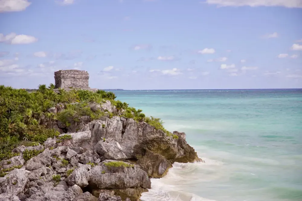 Tulum ruins El Castillo temple on cliff above turquoise Caribbean Sea