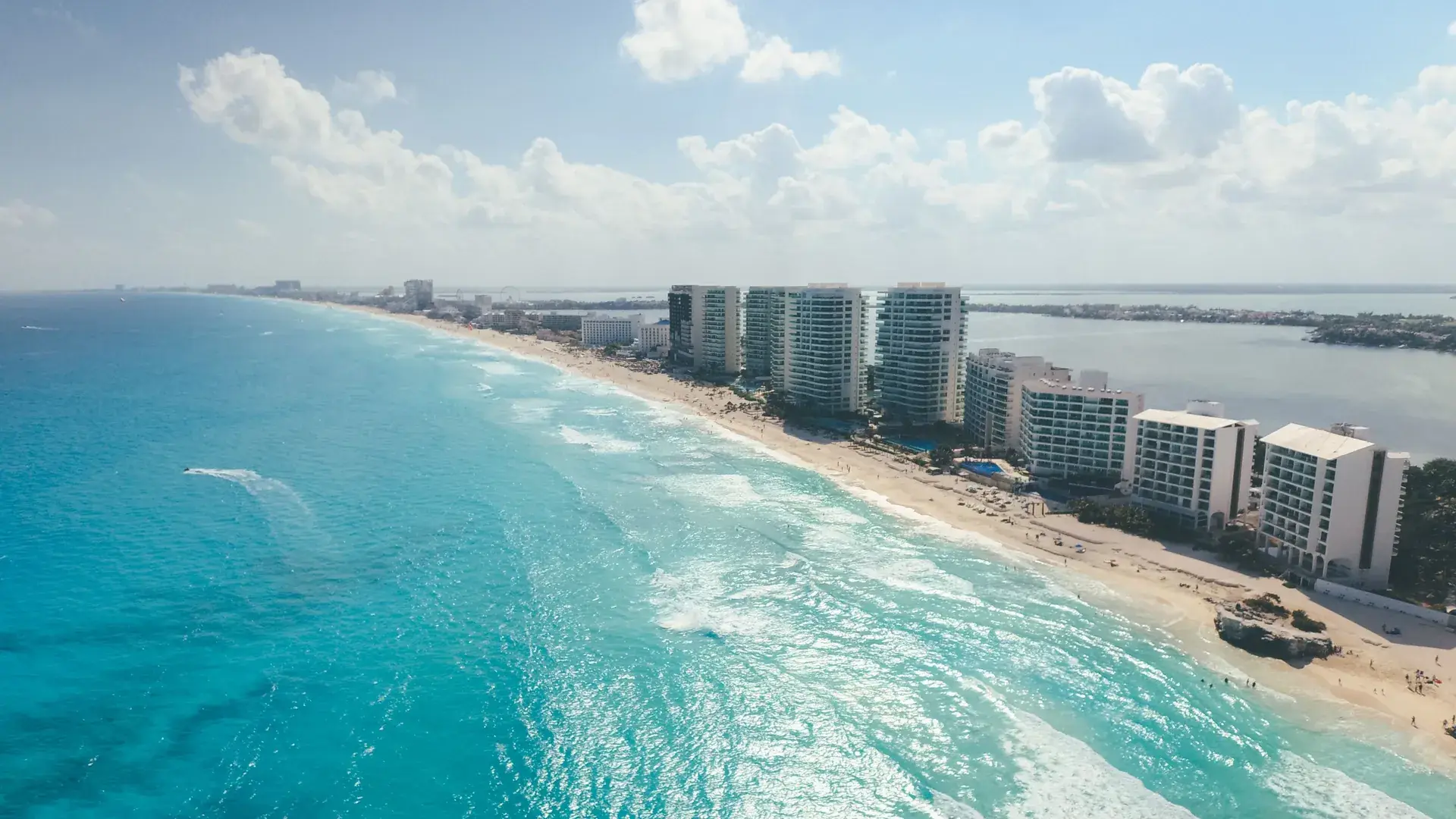 Aerial view of Cancun Hotel Zone beach with turquoise water and beachfront resorts, Quintana Roo Mexico