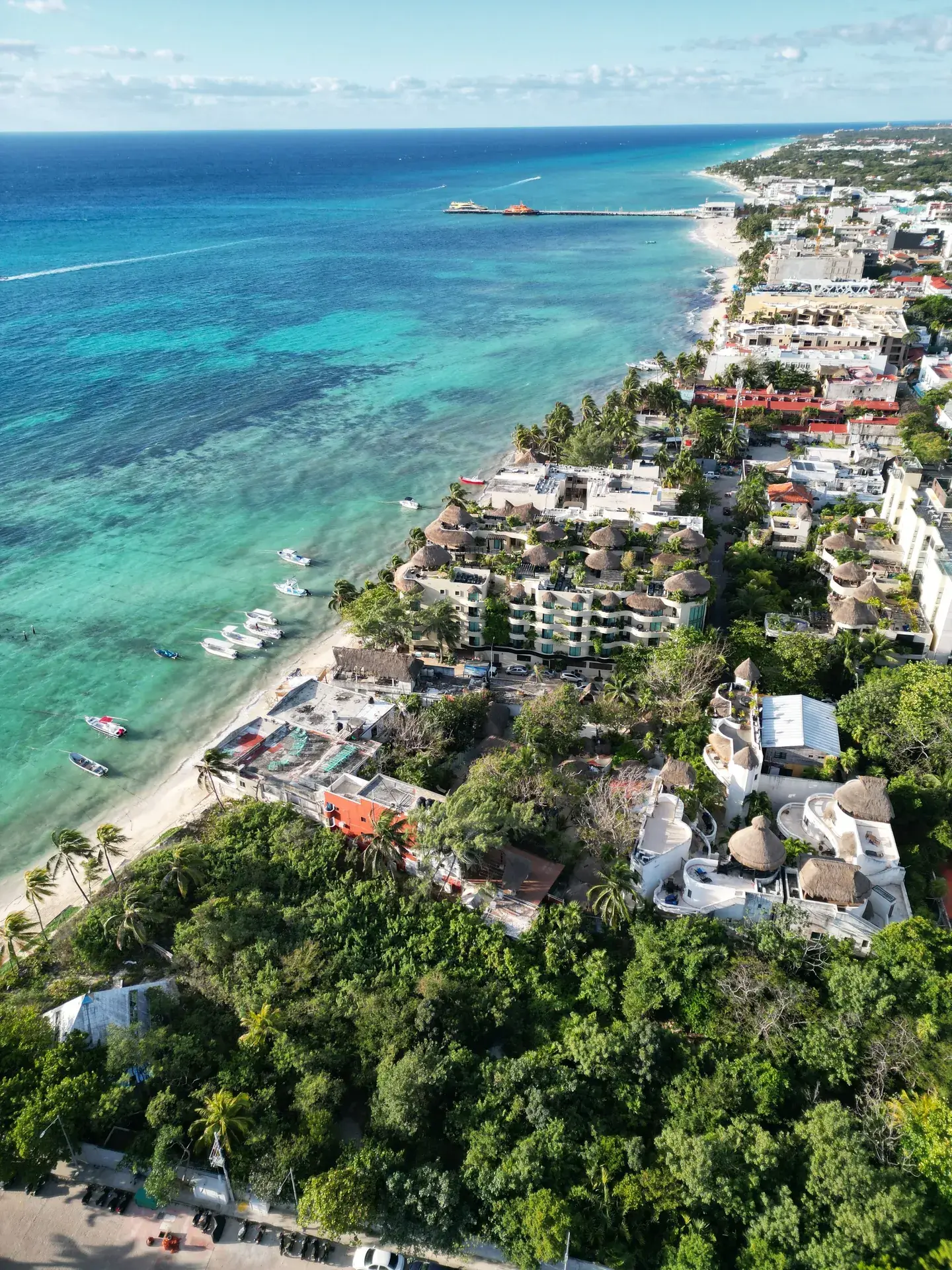 Aerial view of Playa del Carmen beachfront lined with resorts and turquoise water, Riviera Maya Mexico